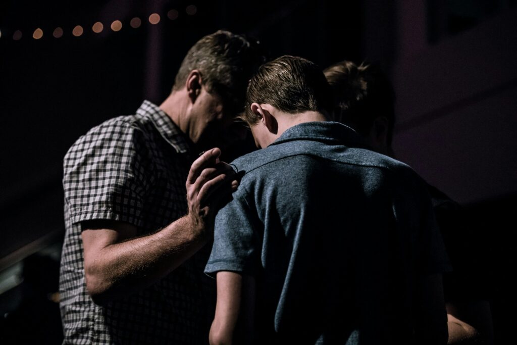 Group huddle in dim lighting